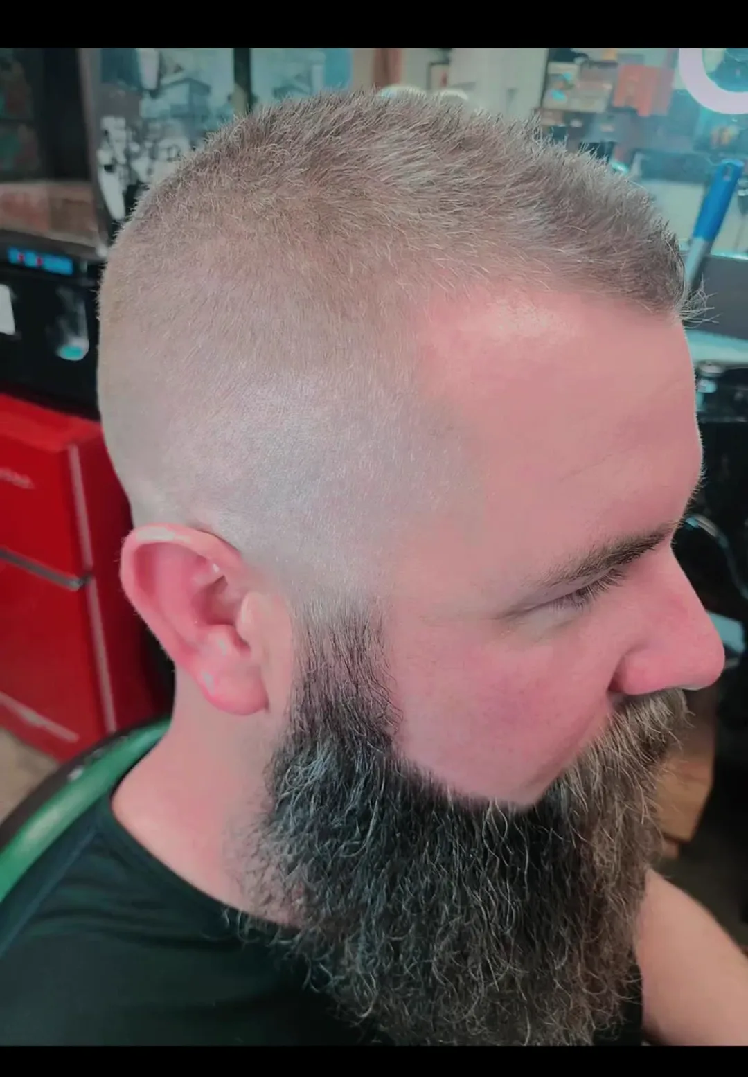 A tight skin fade paired with a sculpted beard — Chavo's work
